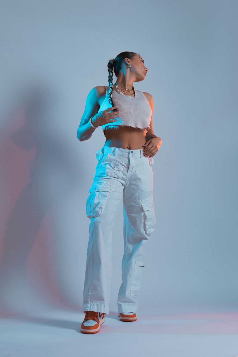 a woman in white pants and a white tank top