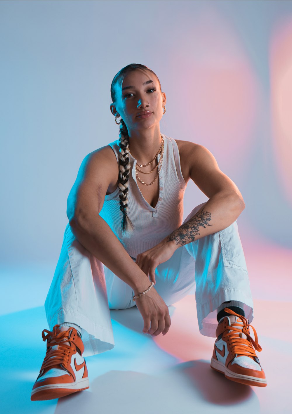 a woman sitting on the ground with her legs crossed