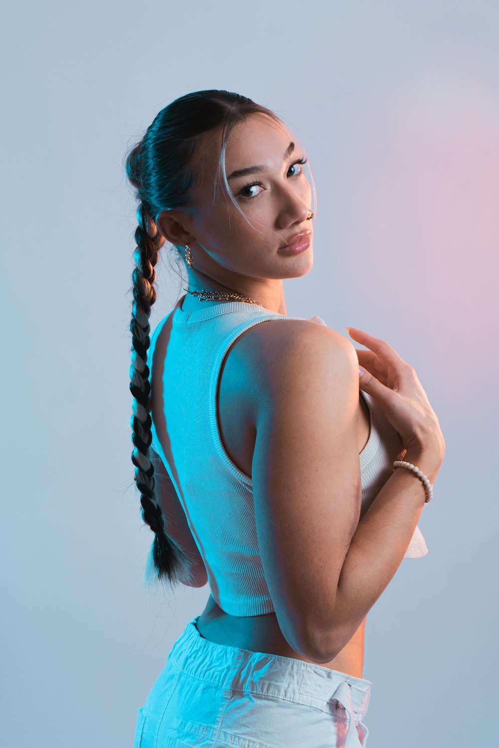 a woman with a ponytail in a tank top