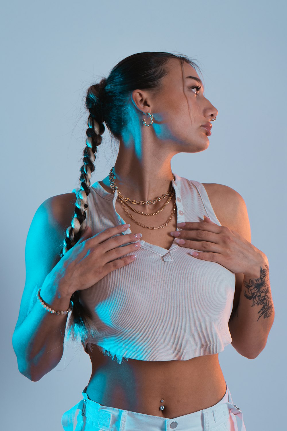 a woman wearing a white crop top with a braid in her hair