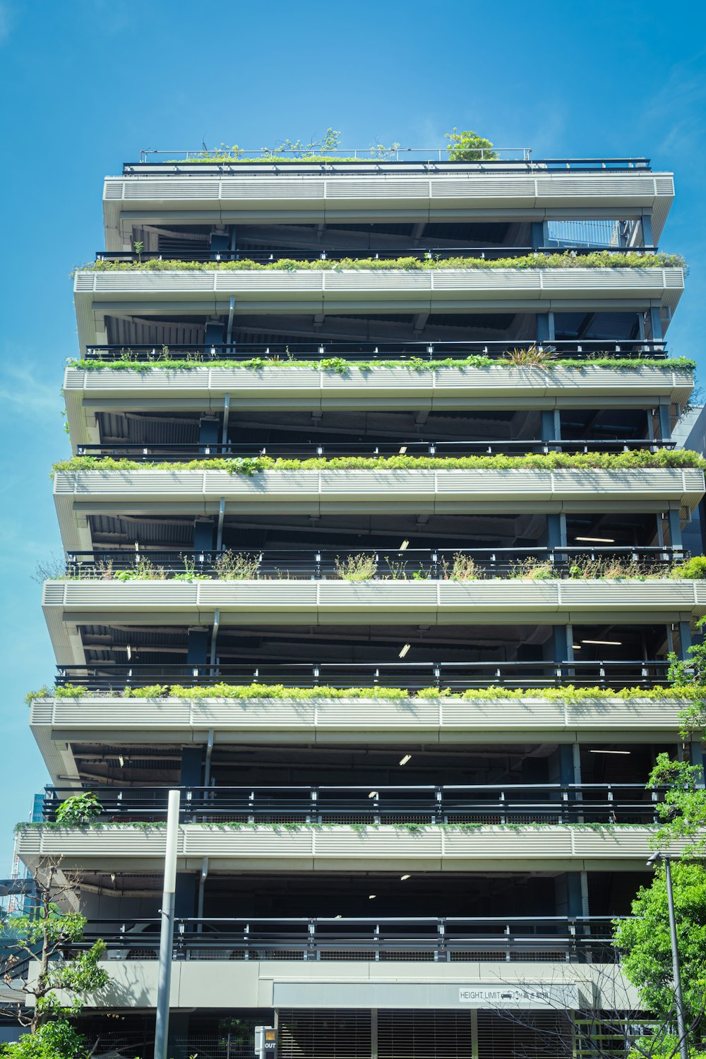 a tall building with a lot of plants growing on it