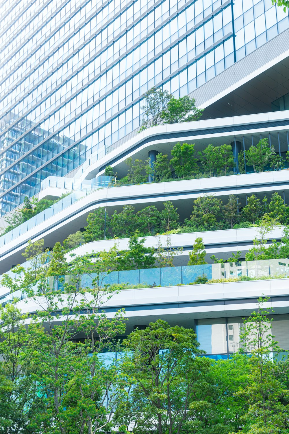 a tall building with a bunch of trees on the side of it