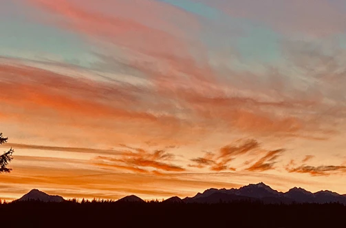 Sunset over the Andes mountains with colorful clouds.