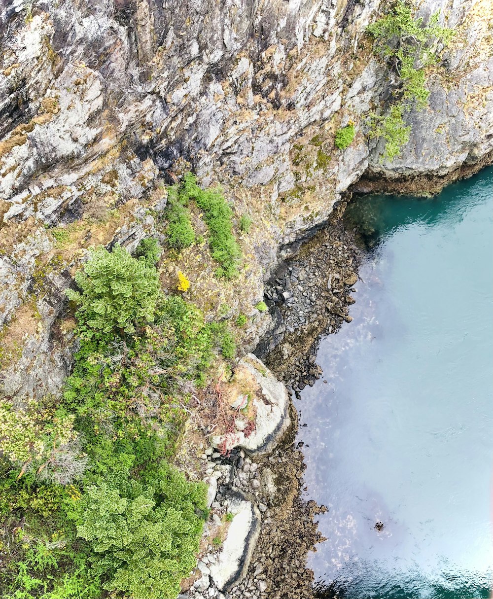 a large body of water surrounded by a rocky cliff