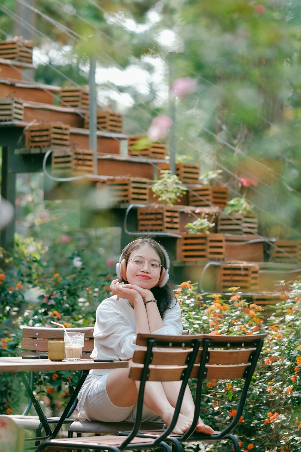 a woman sitting at a table with headphones on