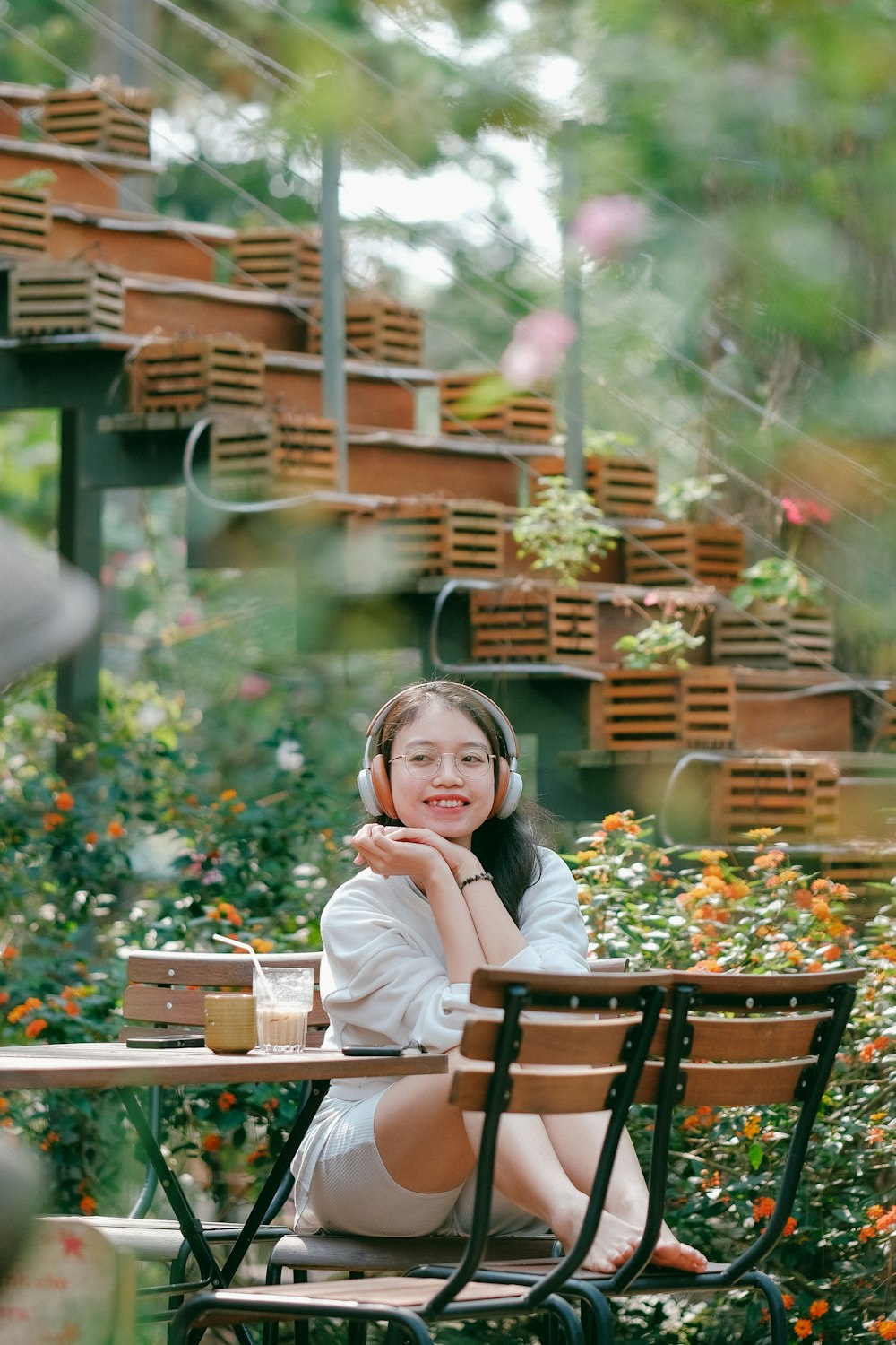 a woman sitting at a table with a cup of coffee