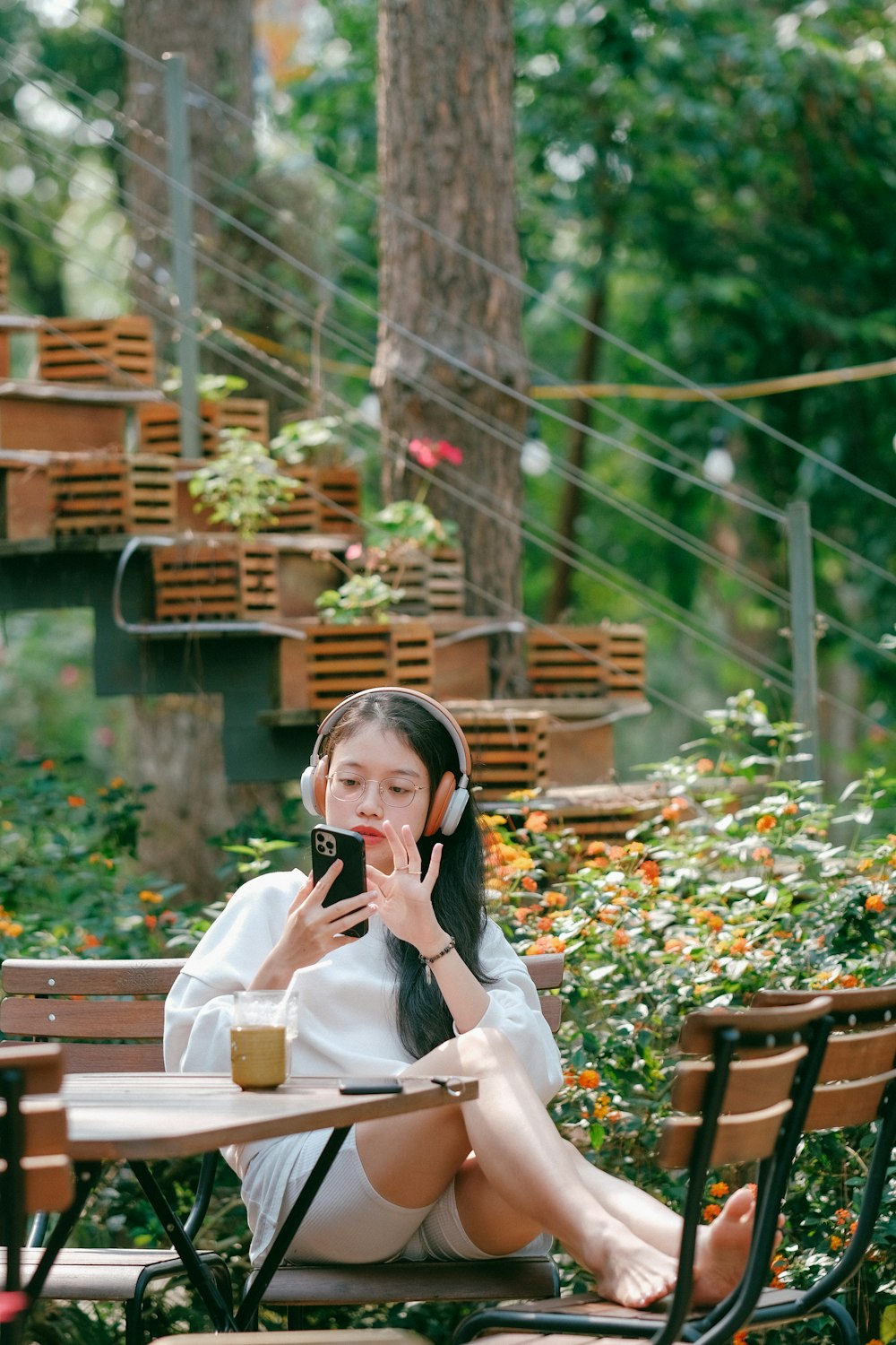 a woman sitting at a table talking on a cell phone