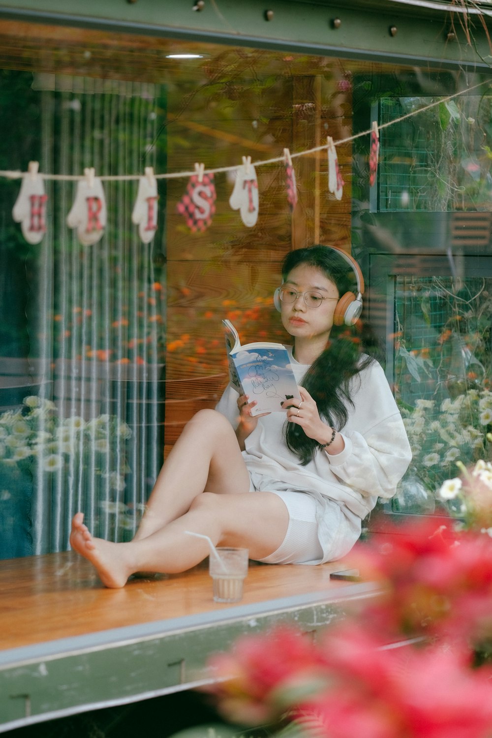 a woman sitting on a bench reading a book