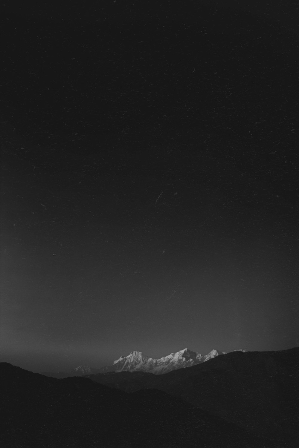 a black and white photo of a mountain range