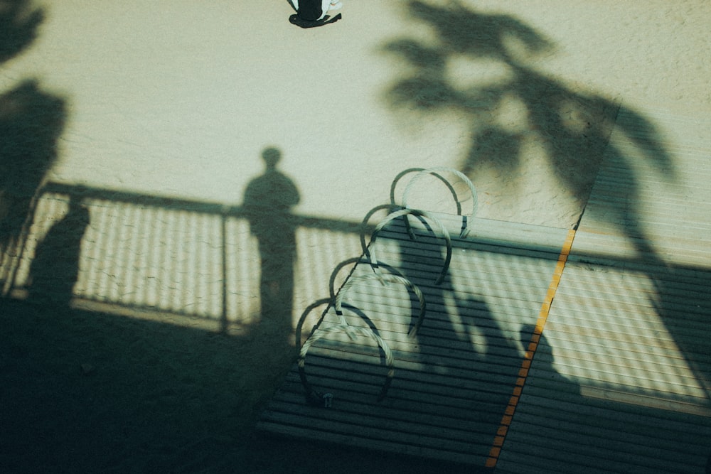 a shadow of a person holding a tennis racquet