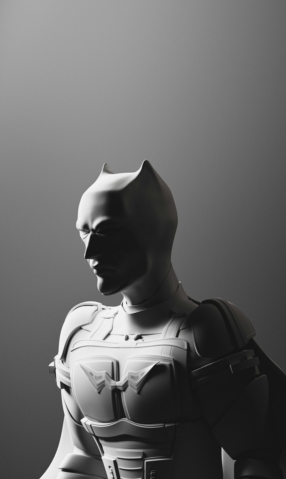 a black and white photo of a batman statue