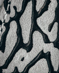 a close up of a black and white pattern on a wall Hand tufted rugs Kanha Universal Export