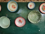 Colorful decorative bowls displayed on a wooden table.