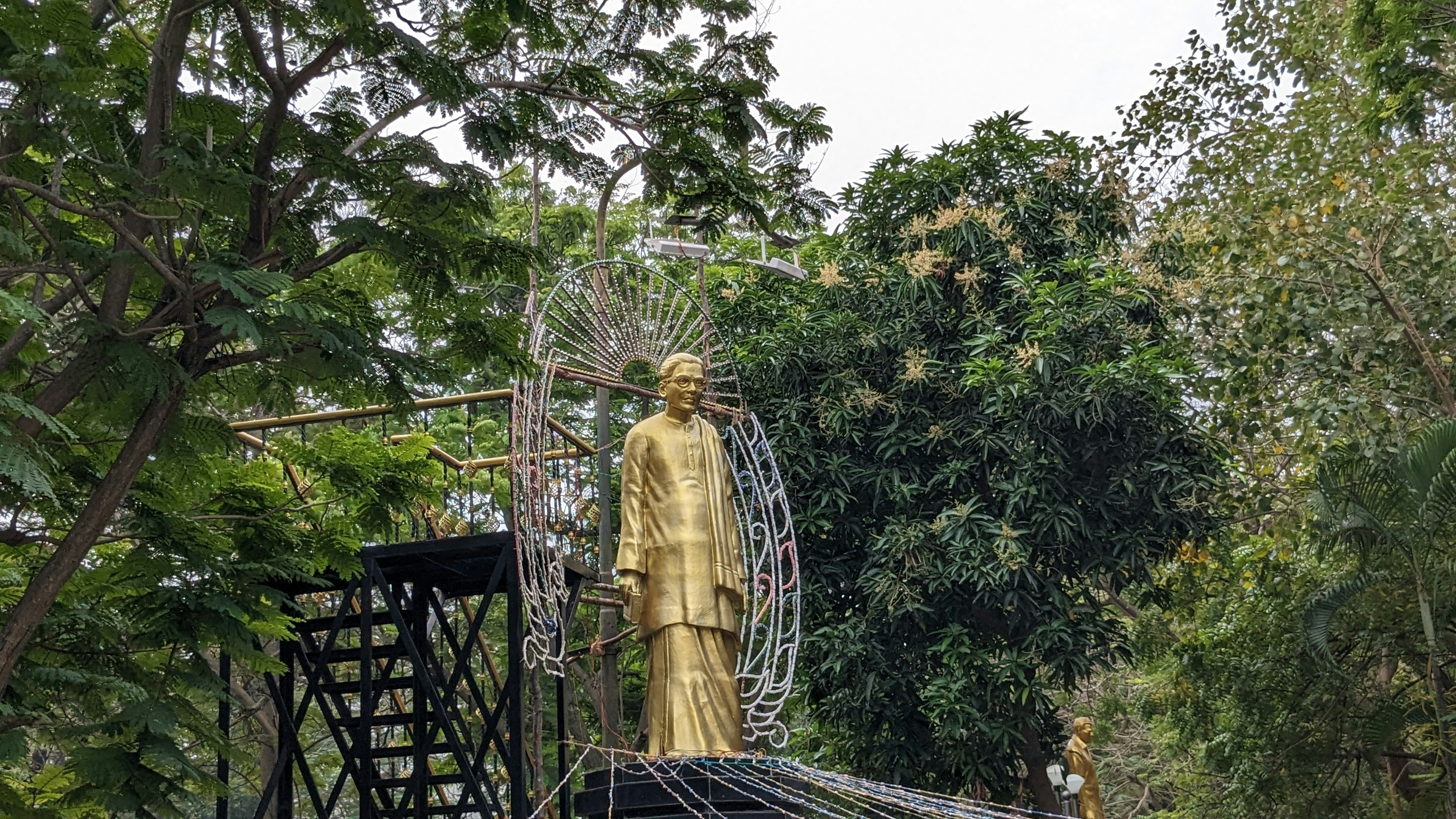 a statue of a man standing on top of a bridge