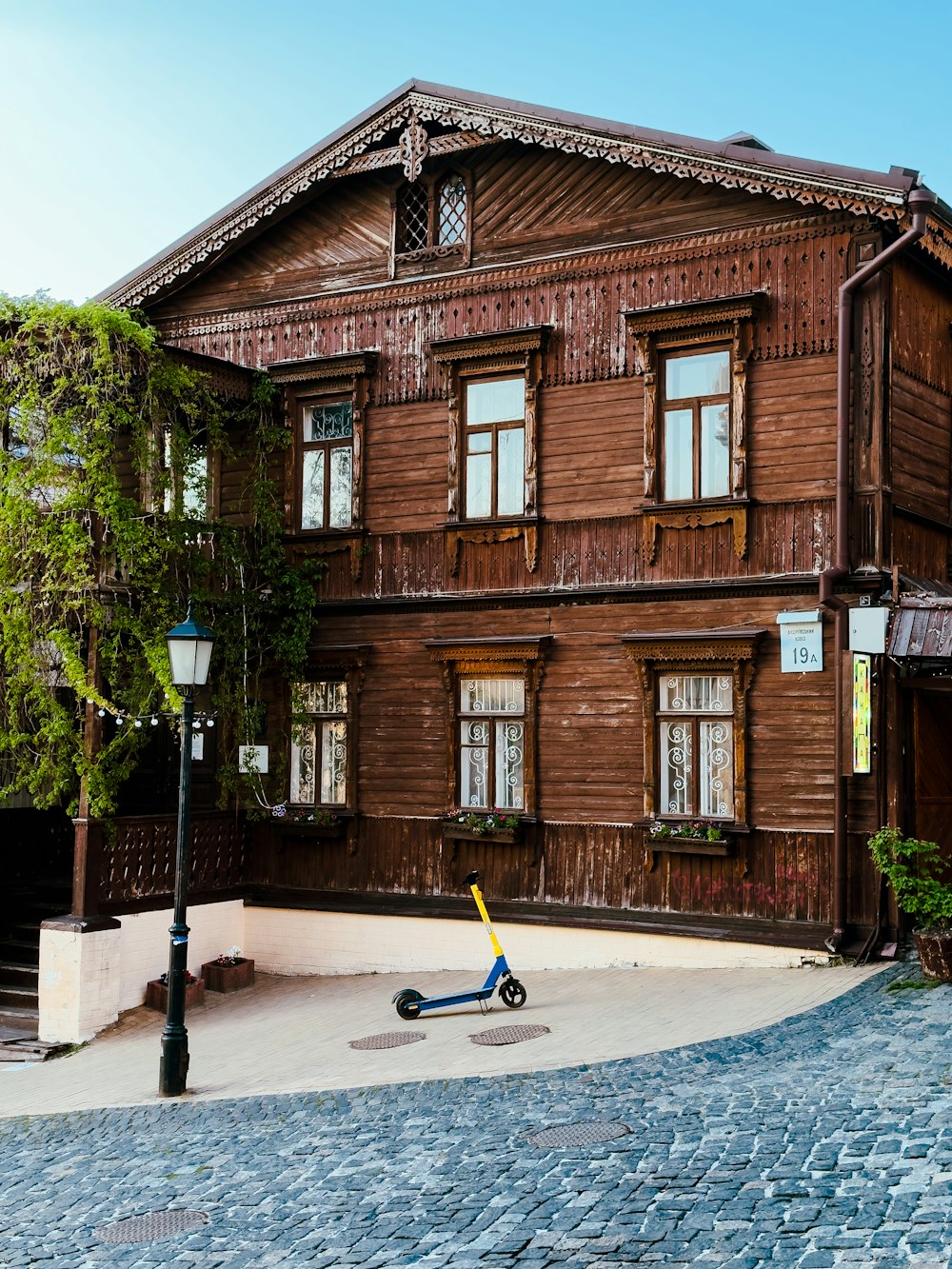 a scooter parked in front of a wooden building