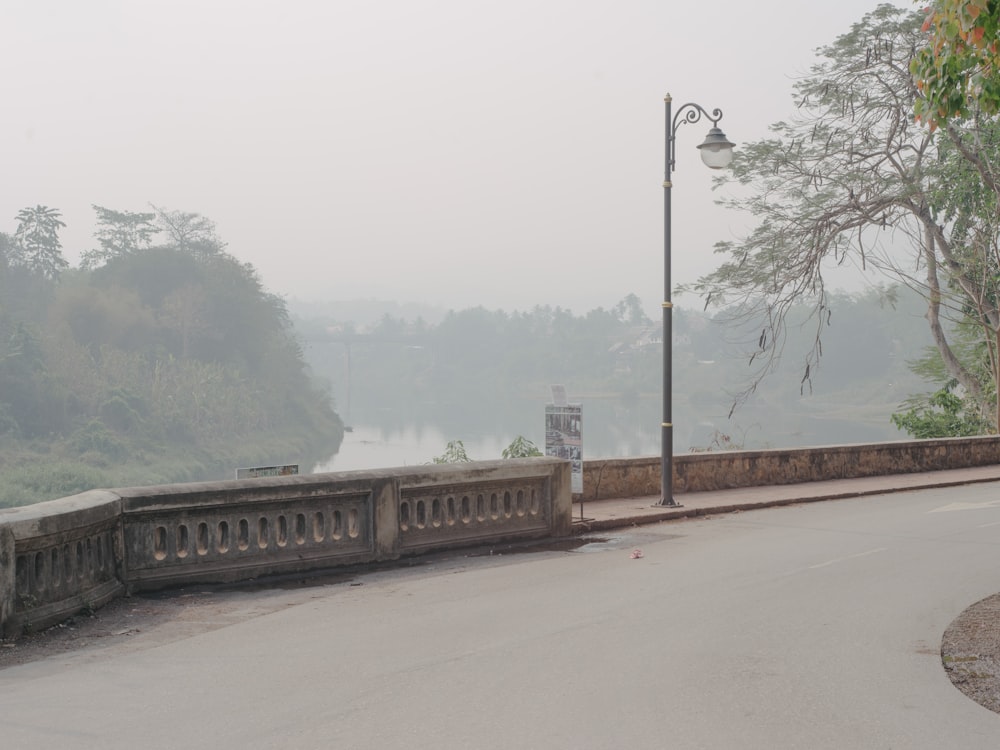 a foggy day on a bridge over a river