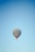 A hot air balloon with the text 'Turkish Aeronautical Association' is floating against a clear blue sky. The balloon has colorful details and logos on the sides.
