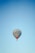 A hot air balloon with the text 'Turkish Aeronautical Association' is floating against a clear blue sky. The balloon has colorful details and logos on the sides.