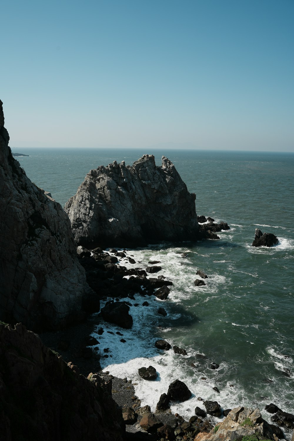 a view of the ocean from the top of a cliff