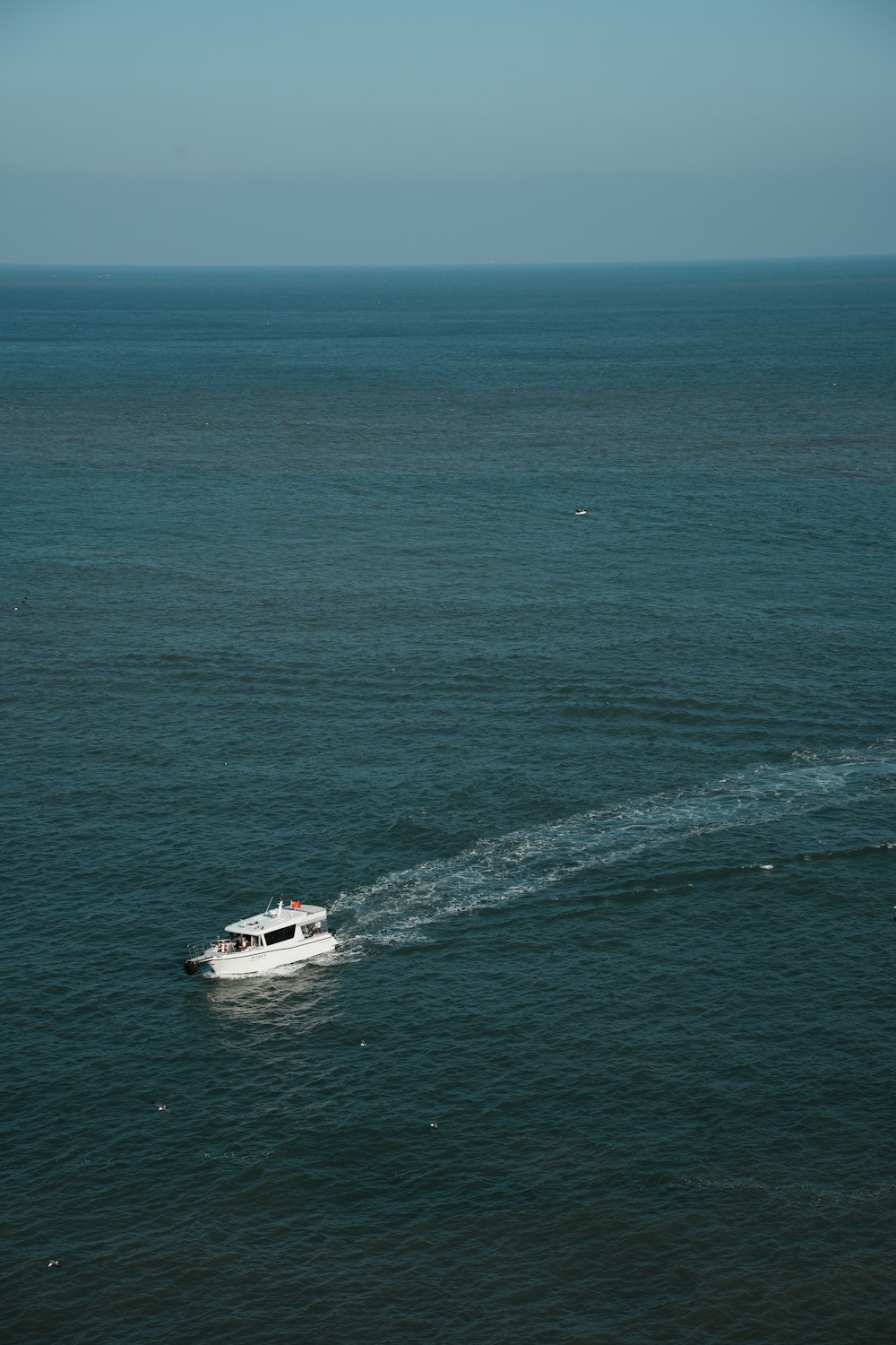 a small boat traveling across a large body of water