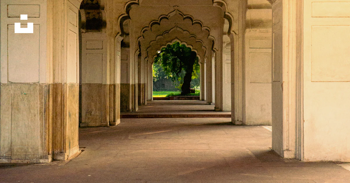 A long hallway with arches and a clock on the wall photo – Free Travel ...