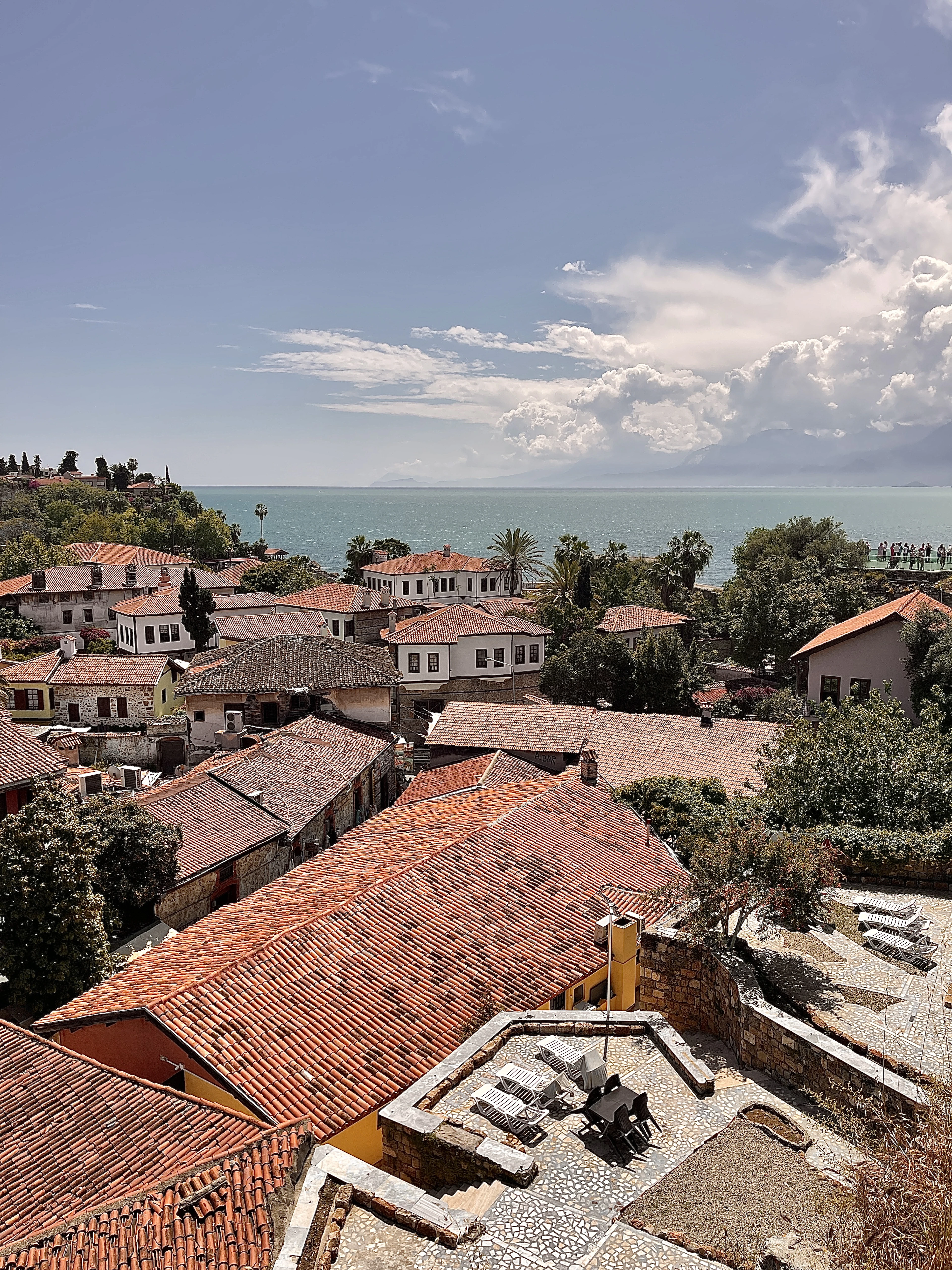 Red-tiled rooftops of Antalya's old town Kaleiçi cascade down toward the turquoise Mediterranean.