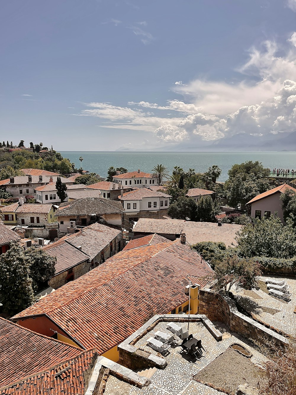 a view of a town with a body of water in the background