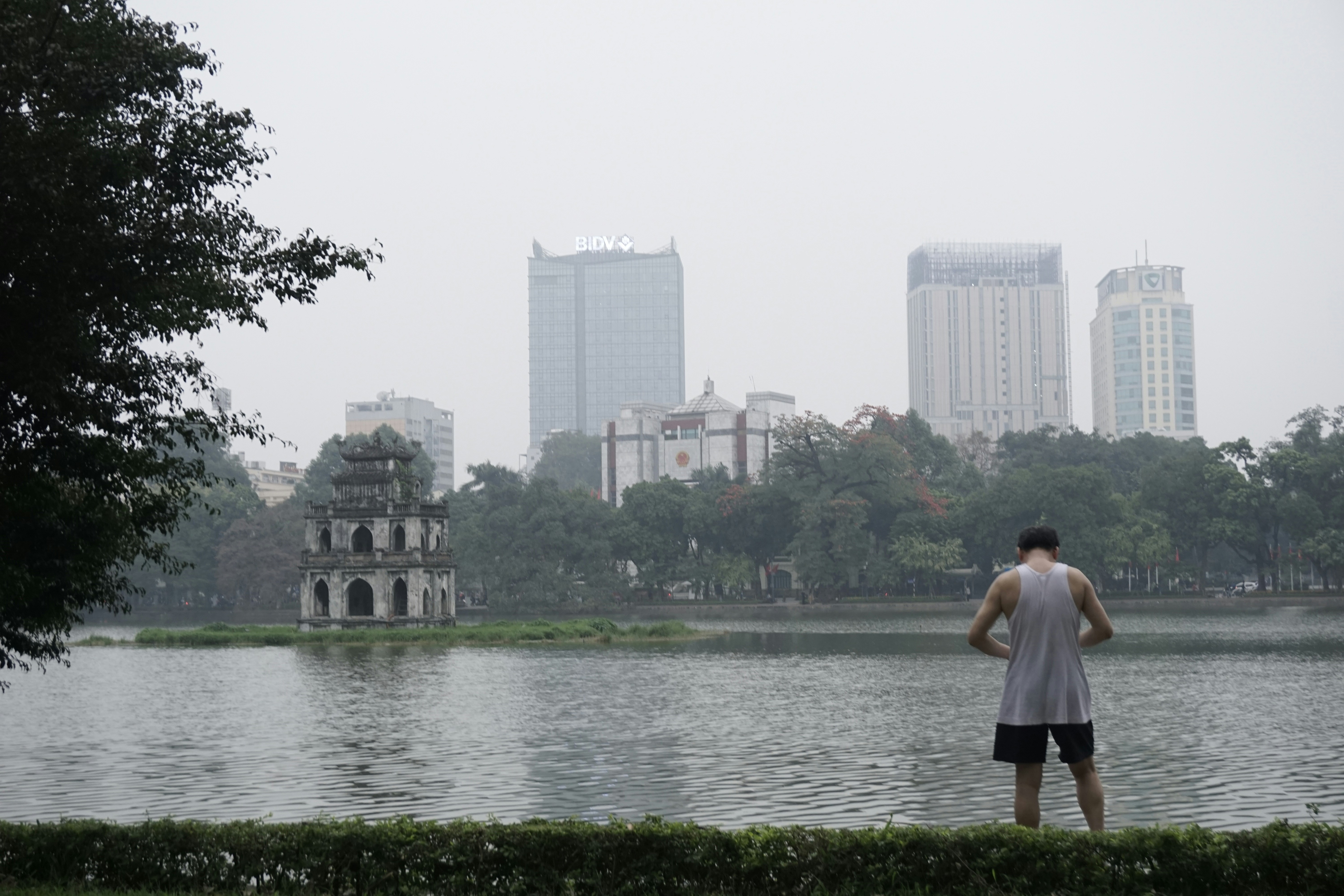 a man standing in front of a body of water