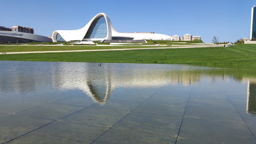 a large body of water with a building in the background