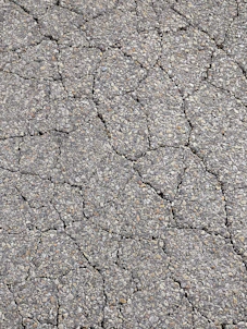 a close up of a cracked asphalt surface