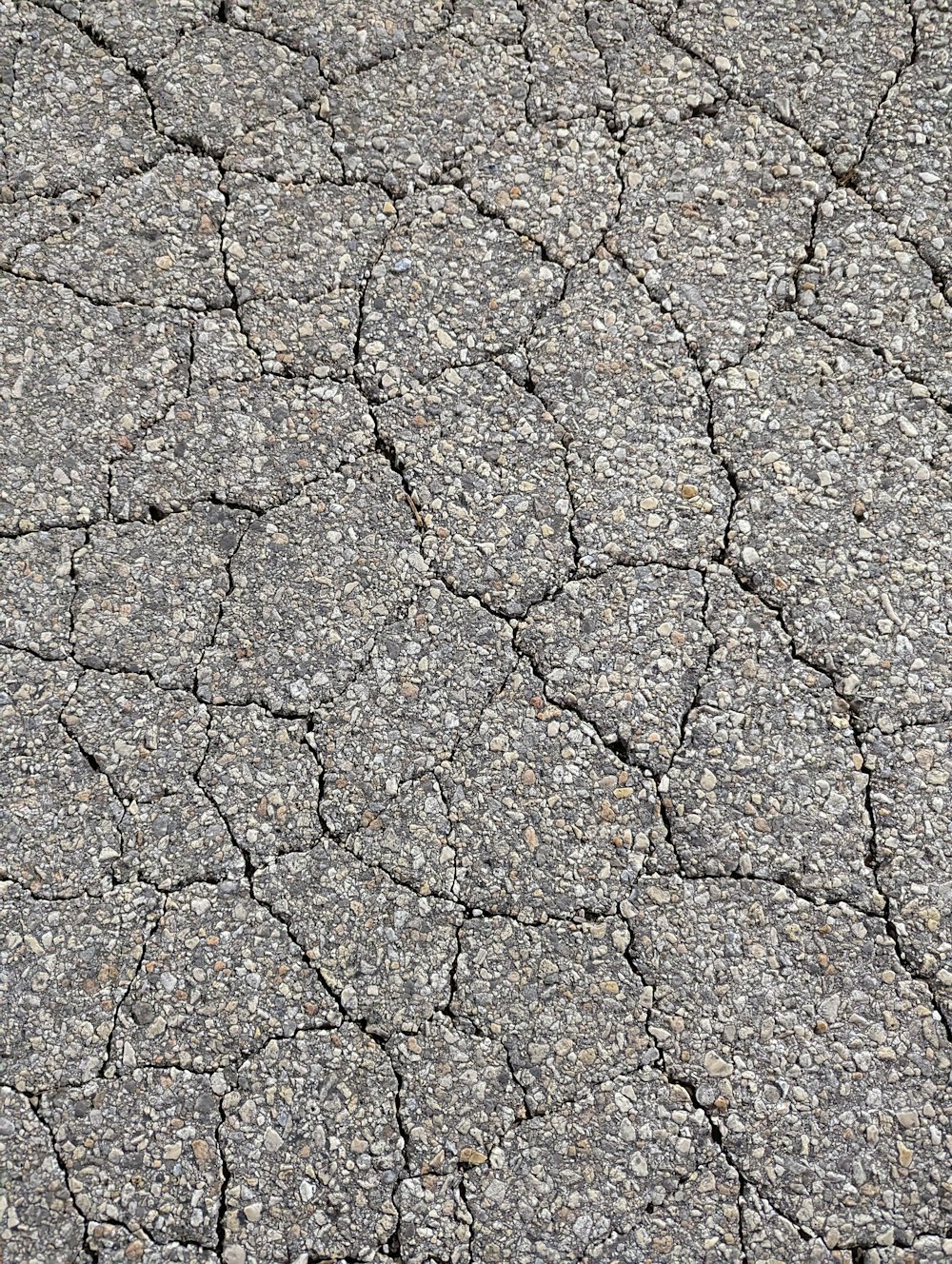 a close up of a cracked asphalt surface