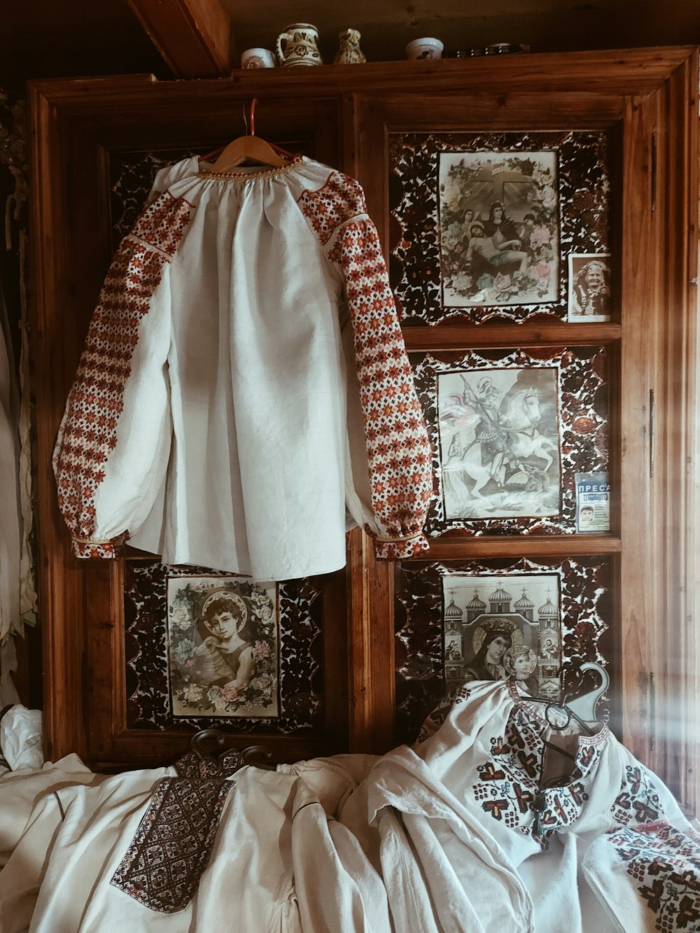 a white shirt hanging on a wooden wall