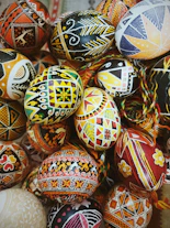 a pile of painted eggs sitting on top of each other