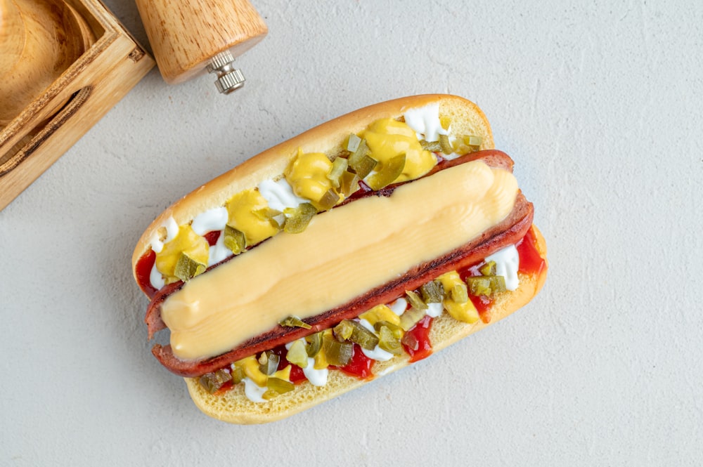 a hot dog with mustard, ketchup, and relish