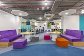 A vibrant office space with modern decor, showcasing a creative environment that fosters teamwork and innovation.
