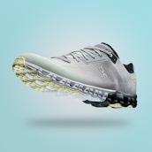 A single sports shoe is prominently displayed against a seamless, light turquoise background. The shoe features a sleek design with a gradient of light gray to dark gray tones, and is equipped with a distinctive CloudTec sole for cushioning. The branding logo is subtly visible on the side.