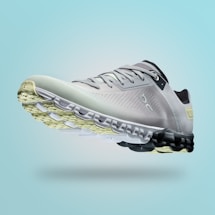A single sports shoe is prominently displayed against a seamless, light turquoise background. The shoe features a sleek design with a gradient of light gray to dark gray tones, and is equipped with a distinctive CloudTec sole for cushioning. The branding logo is subtly visible on the side.
