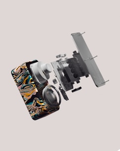 a multicolored cell phone is flying through the air