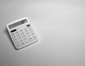 a white calculator sitting on top of a table