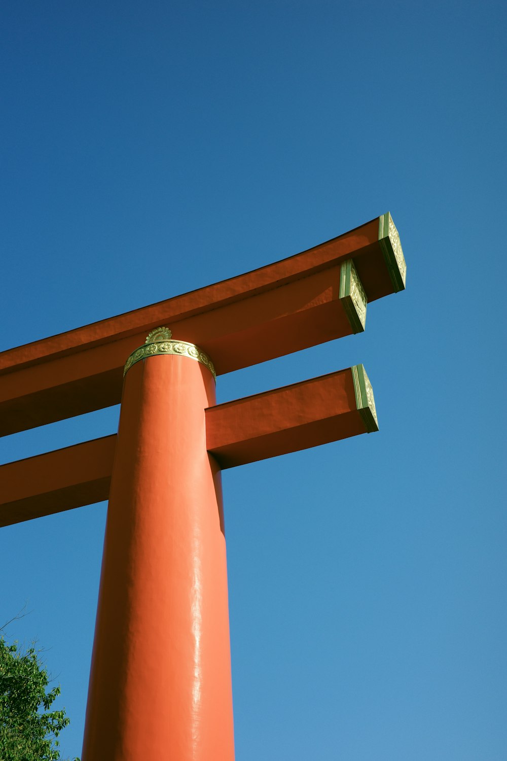 a tall orange object with a blue sky in the background