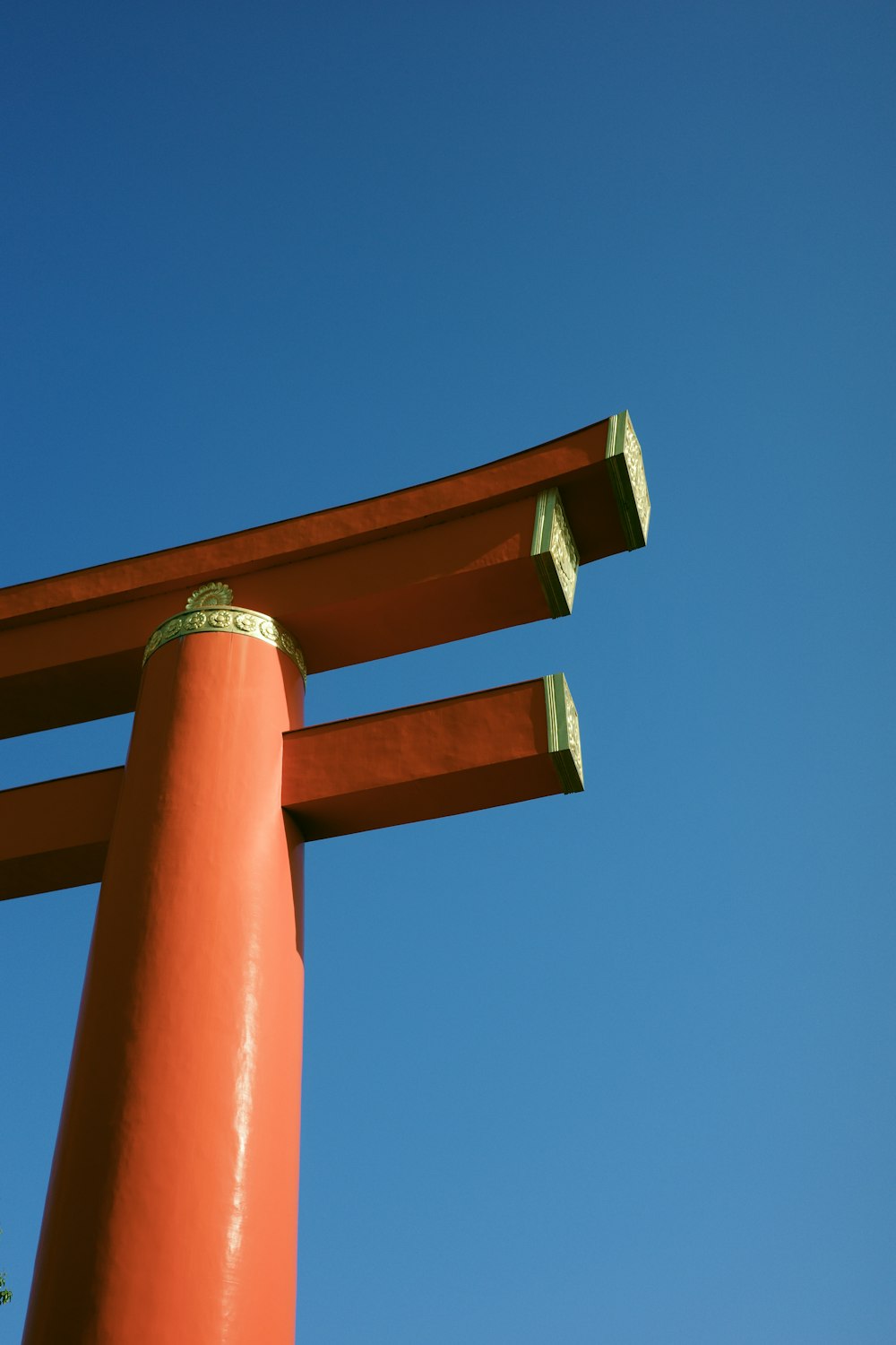 a tall orange structure with a blue sky in the background