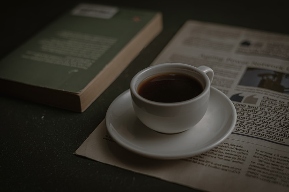 a cup of coffee sitting on top of a white saucer