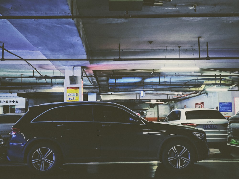 a car parked in a parking garage next to another car