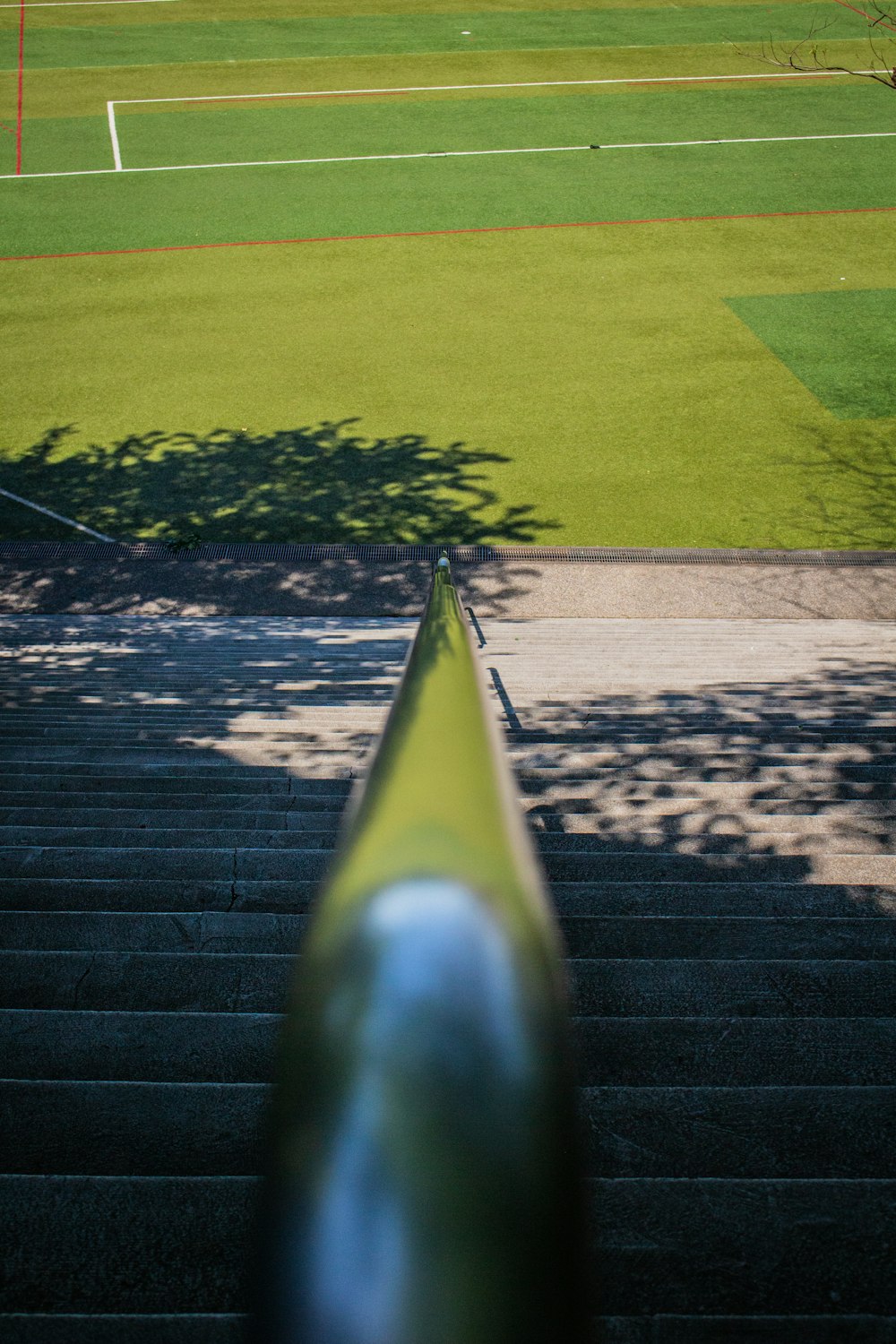 a view of a tennis court from the top of a set of stairs