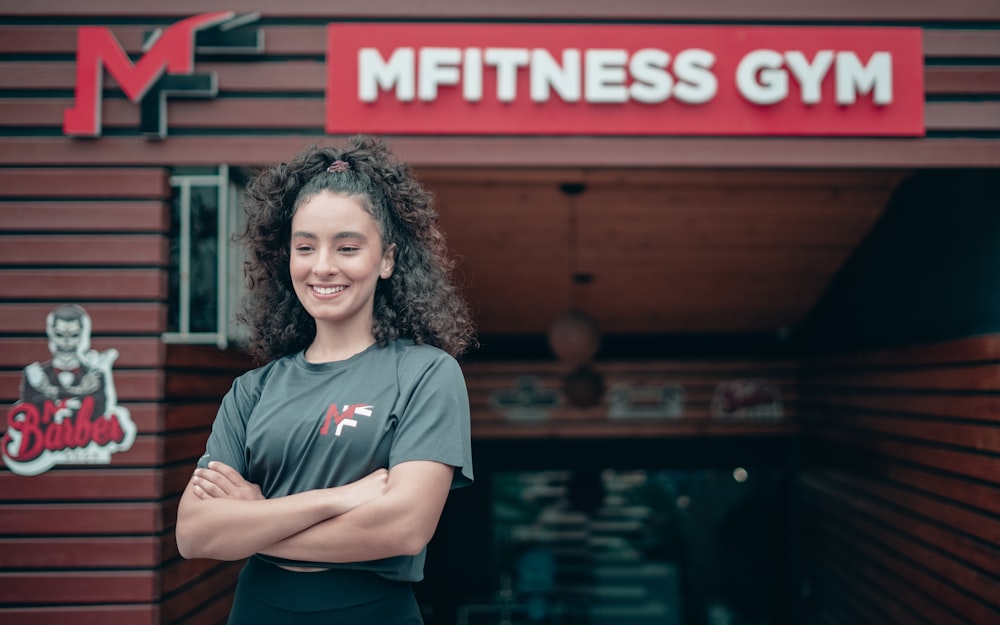a woman standing in front of a gym