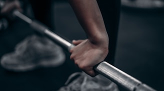 A close-up of a personal trainer guiding a client with weights.