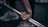 Close-up of hands adjusting gym equipment with focus on strength training.