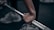 Close-up of hands adjusting gym equipment with focus on strength training.