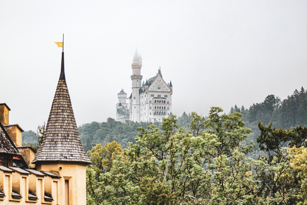 a castle in the distance with trees in the foreground