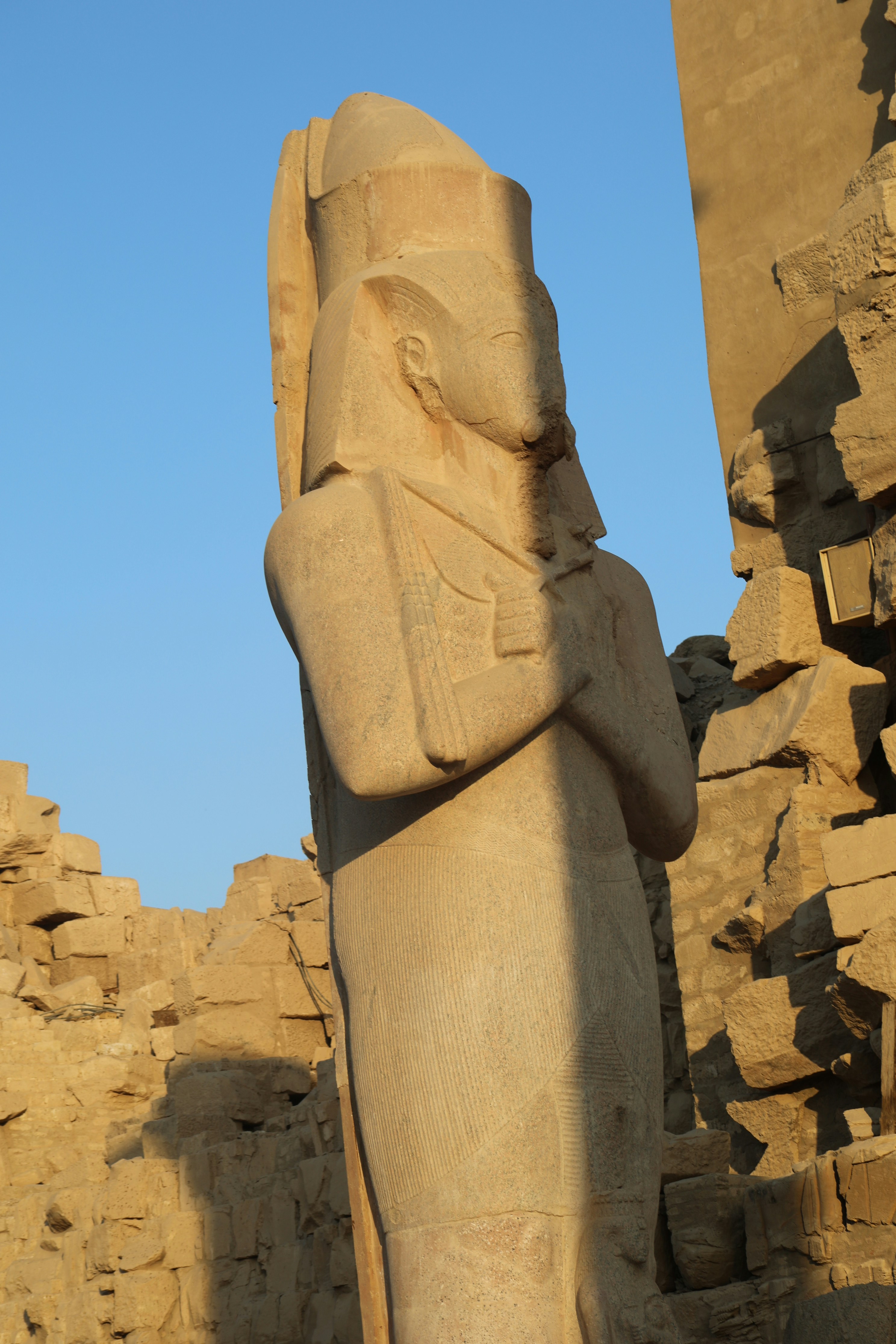 a statue of an egyptian god in front of a building